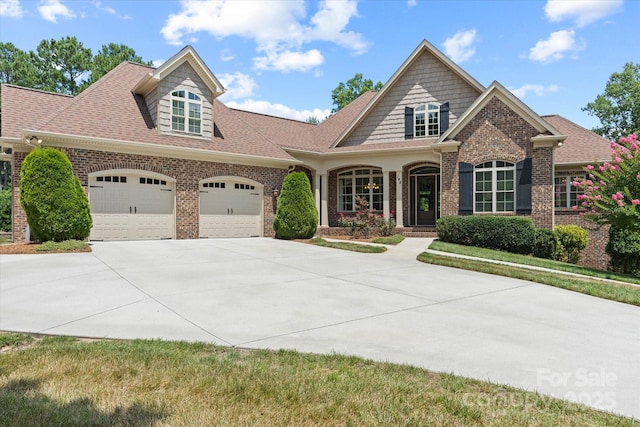 view of front of home with a garage, concrete driveway, and brick siding