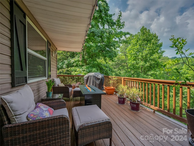 wooden terrace featuring an outdoor living space and area for grilling