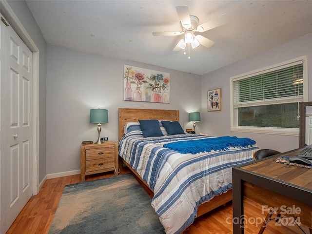 bedroom featuring ceiling fan, hardwood / wood-style flooring, and a closet