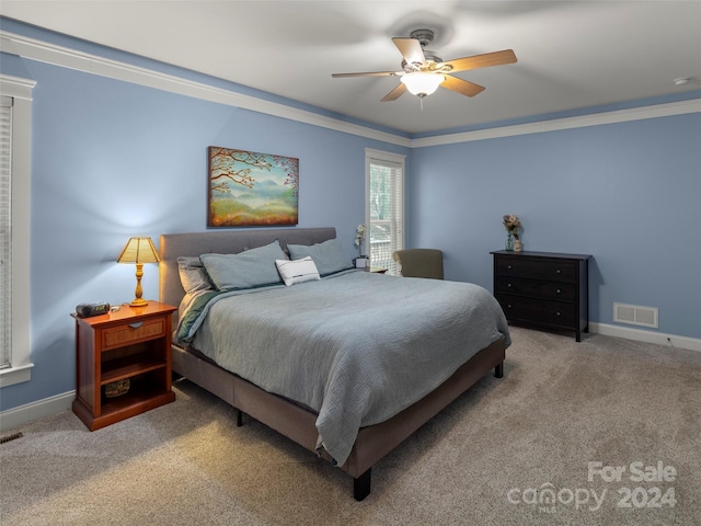 bedroom with carpet, ceiling fan, and crown molding