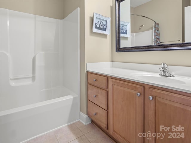 bathroom featuring tile patterned flooring, vanity, and washtub / shower combination