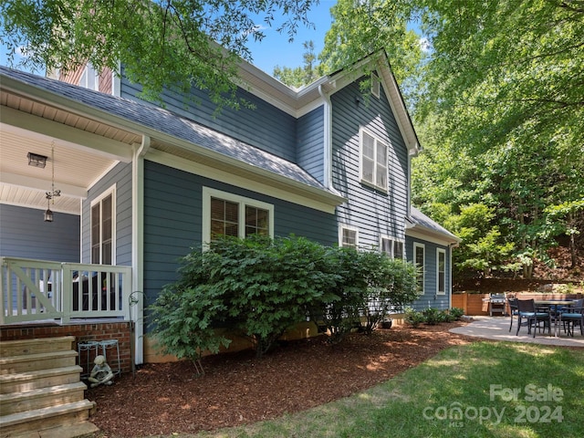 view of side of home with a patio area