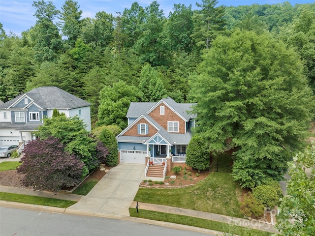 view of front of property featuring a front yard and a garage