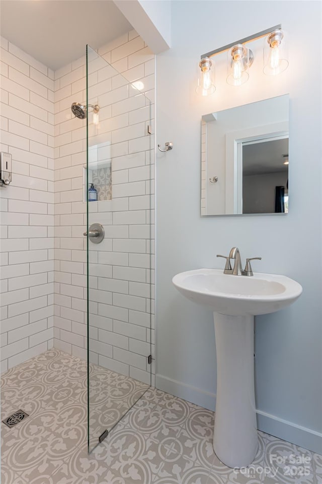 bathroom featuring tile patterned floors and a tile shower