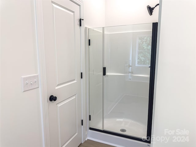 bathroom with a shower with shower door