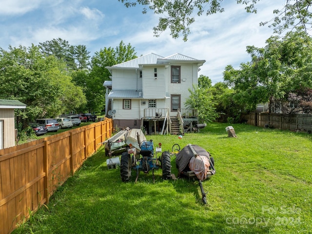 rear view of property with a yard