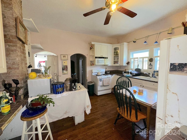 kitchen with white appliances, white cabinets, dark wood-type flooring, sink, and ceiling fan