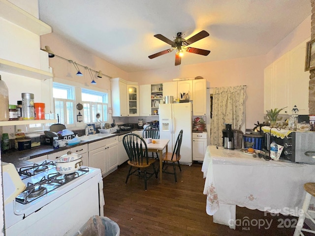 kitchen with white appliances, white cabinets, sink, dark hardwood / wood-style floors, and ceiling fan