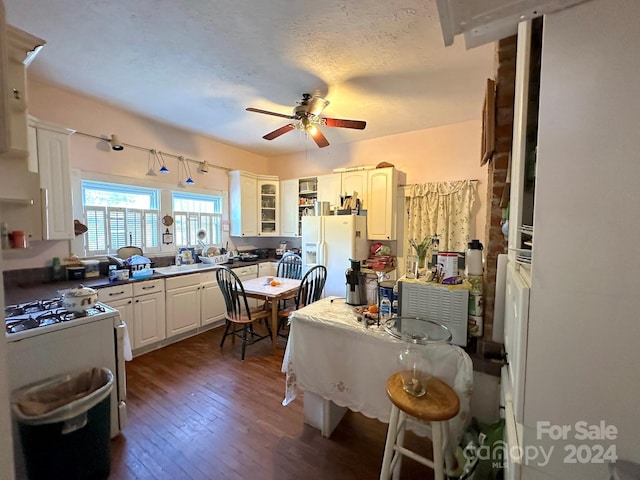 kitchen featuring ceiling fan, white appliances, dark wood-type flooring, a textured ceiling, and white cabinets