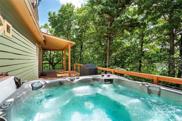 view of swimming pool with a hot tub and a deck