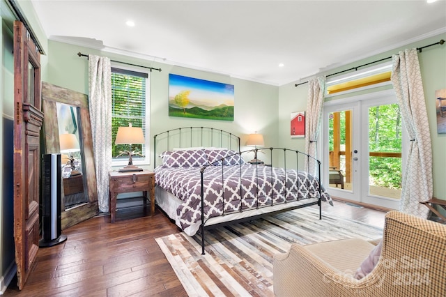 bedroom featuring access to exterior, dark hardwood / wood-style flooring, ornamental molding, and french doors