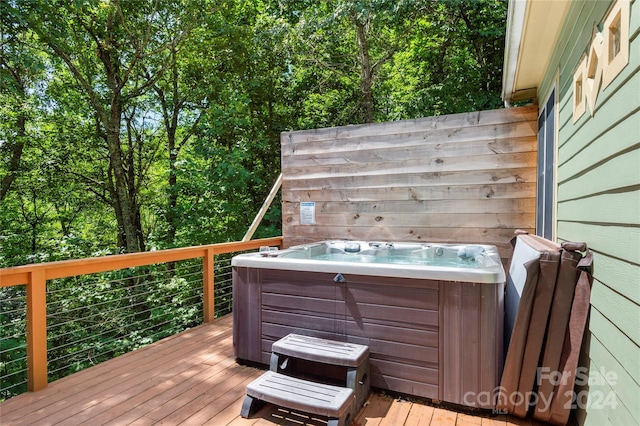 wooden deck with a hot tub