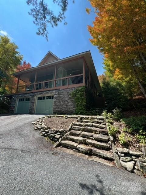 view of front of house featuring a garage and a balcony