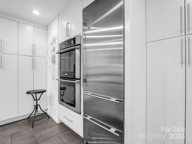 kitchen with white cabinetry and appliances with stainless steel finishes