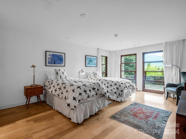 bedroom featuring light hardwood / wood-style floors and access to exterior