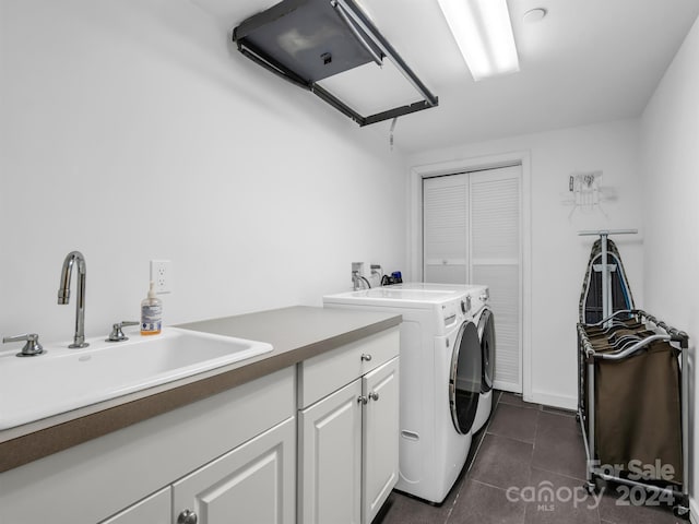 washroom with separate washer and dryer, sink, and cabinets