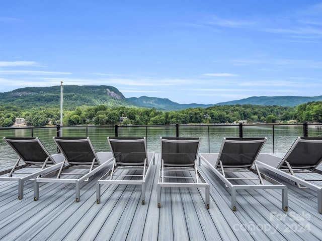 deck with a water and mountain view