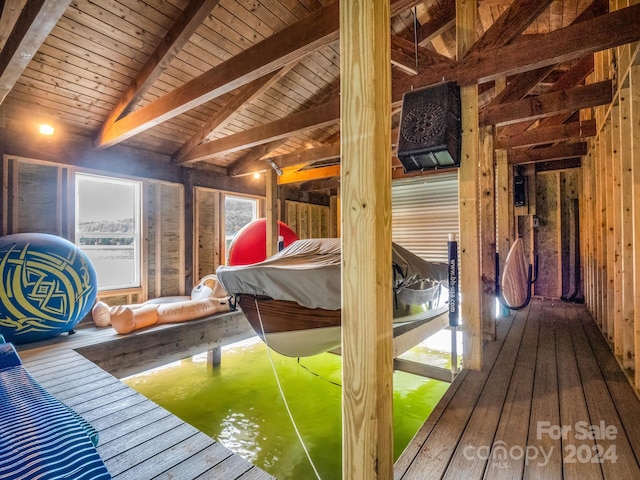 interior space with lofted ceiling with beams, hardwood / wood-style flooring, and wood ceiling