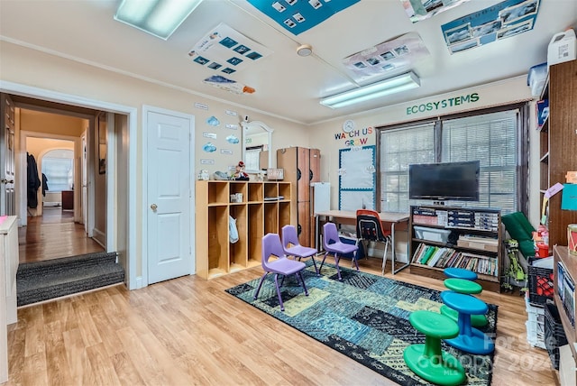 rec room featuring crown molding and wood-type flooring