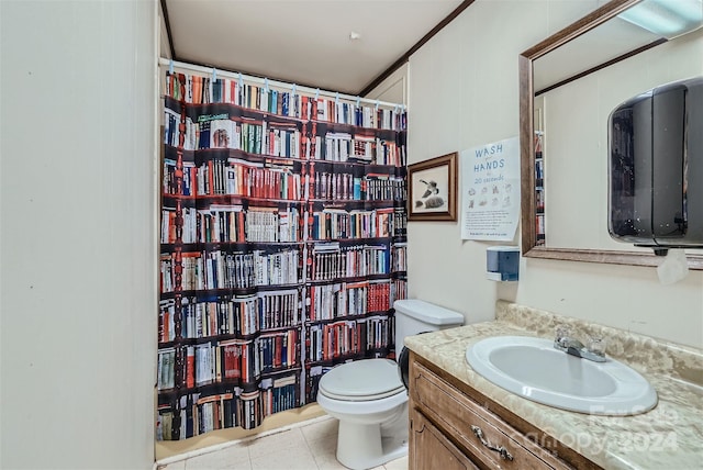 bathroom with tile patterned flooring, vanity, and toilet