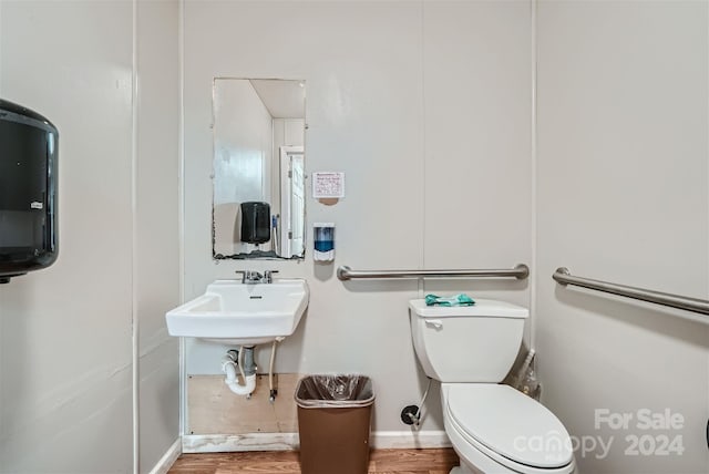 bathroom featuring sink, wood-type flooring, and toilet