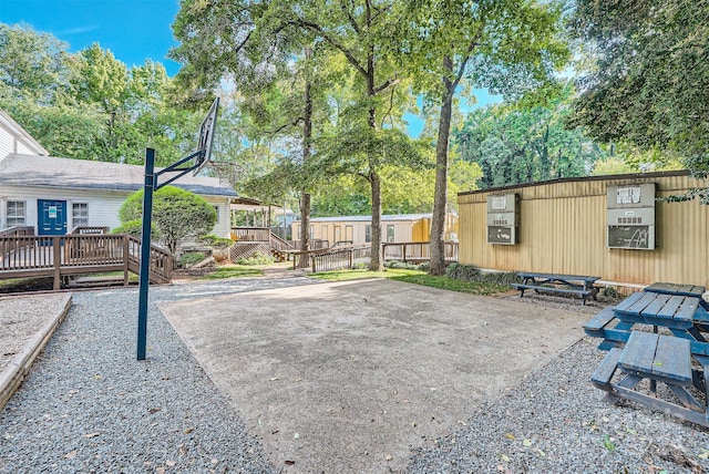 view of patio / terrace with basketball court and a deck