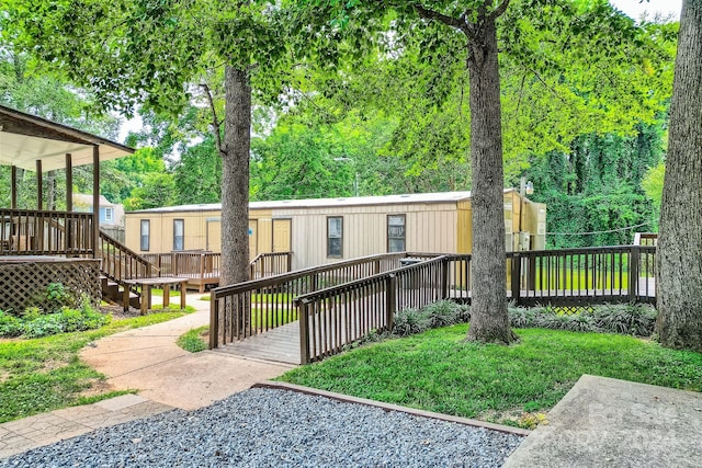 view of front of home with a deck and a front lawn