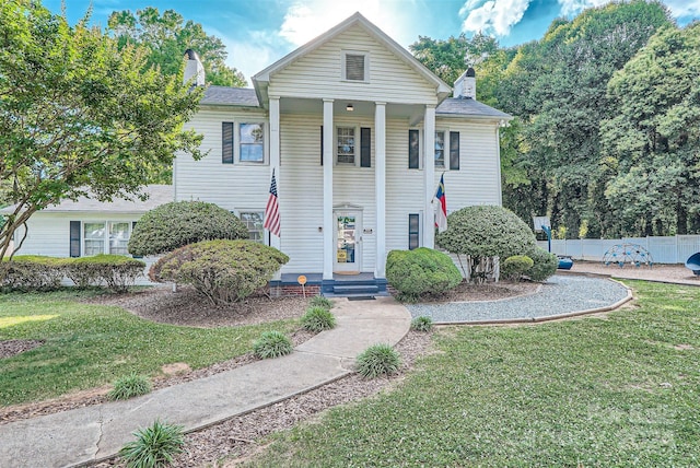 greek revival house with a front yard