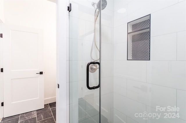 bathroom with a shower with shower door