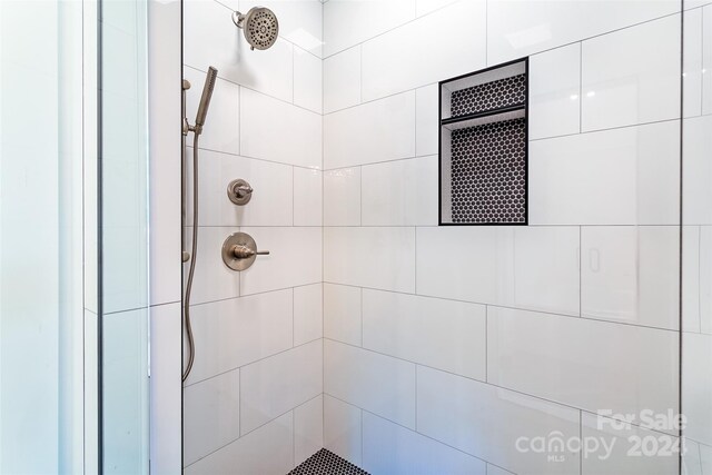 bathroom with tiled shower