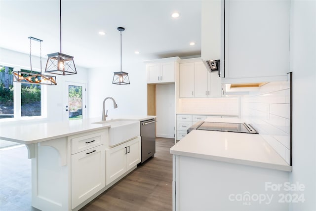 kitchen with white cabinets, dishwasher, a kitchen island with sink, light countertops, and pendant lighting