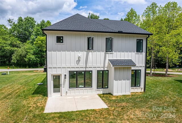 back of property featuring a lawn and a patio