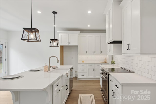 kitchen with appliances with stainless steel finishes, white cabinets, and light countertops