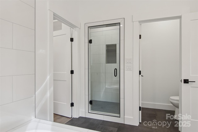 full bathroom with a stall shower and toilet