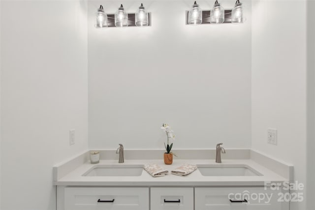 bathroom featuring a sink and double vanity