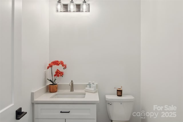 half bathroom featuring toilet and vanity