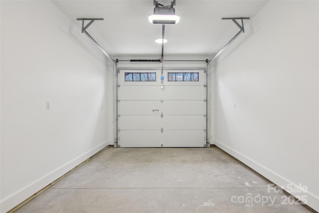 garage with a garage door opener and baseboards