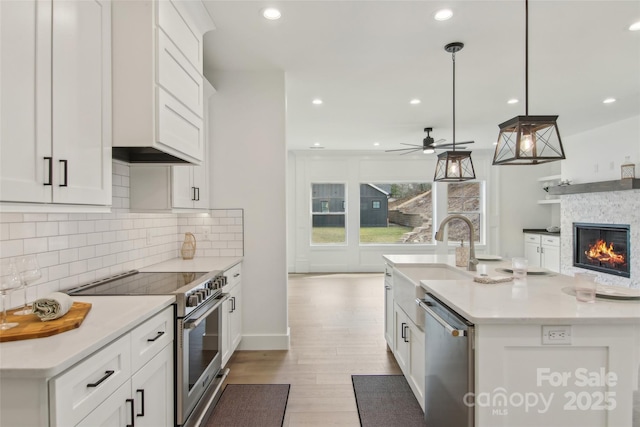 201 Plato Pl, Etowah, NC 28729 - kitchen with recessed lighting, white cabinets, light wood-style floors, appliances with stainless steel finishes, and backsplash
