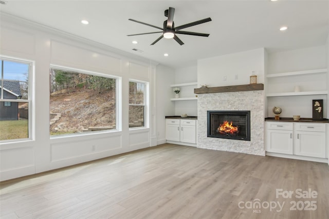 201 Plato Pl, Etowah, NC 28729 - unfurnished living room with built in features, plenty of natural light, and light wood finished floors