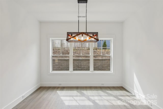 201 Plato Pl, Etowah, NC 28729 - unfurnished dining area with baseboards and light wood-style flooring