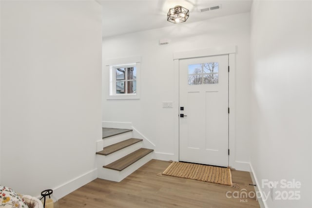 201 Plato Pl, Etowah, NC 28729 - foyer entrance with visible vents, light wood-style flooring, stairway, and baseboards