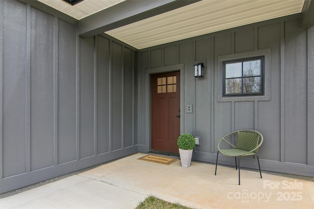 entrance to property featuring covered porch and board and batten siding