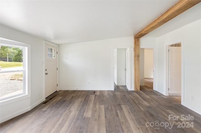 interior space featuring beam ceiling and dark hardwood / wood-style flooring