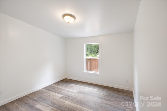 spare room with light hardwood / wood-style flooring