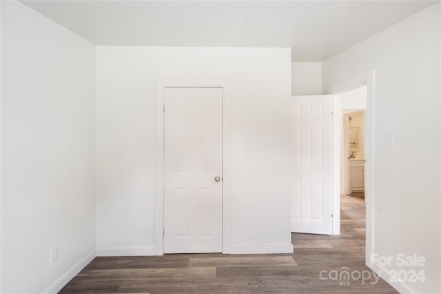 unfurnished bedroom featuring dark hardwood / wood-style floors