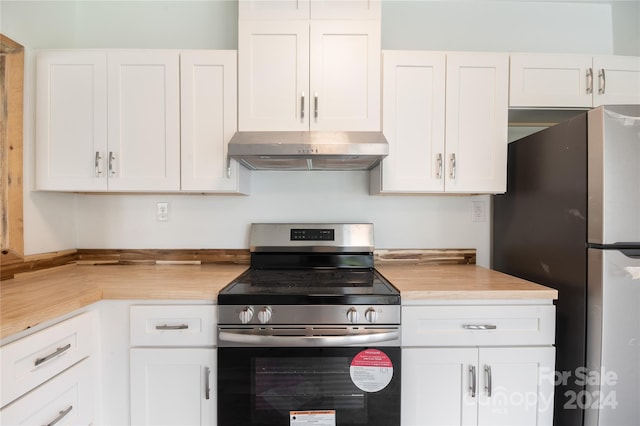 kitchen with white cabinets, appliances with stainless steel finishes, and extractor fan