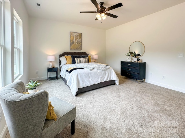 bedroom featuring ceiling fan and light carpet