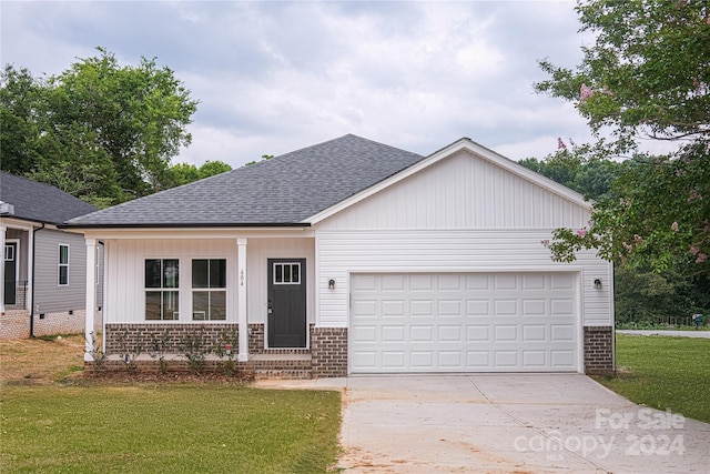 view of front of home with a garage and a front lawn