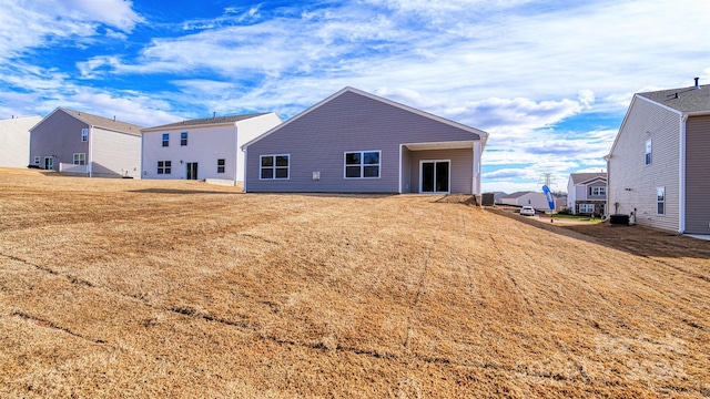 rear view of property with central AC unit