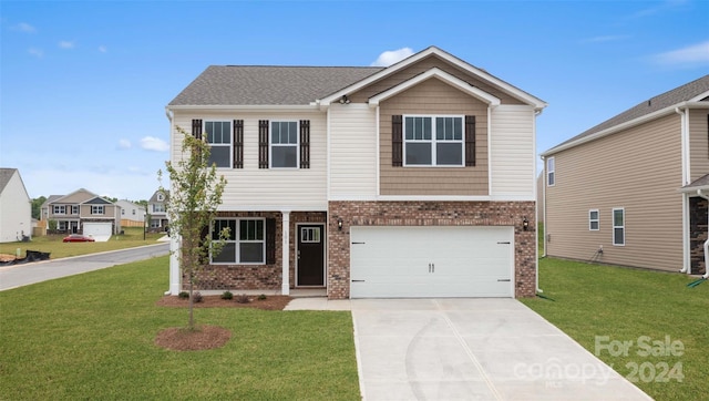 view of front of property featuring a front yard and a garage